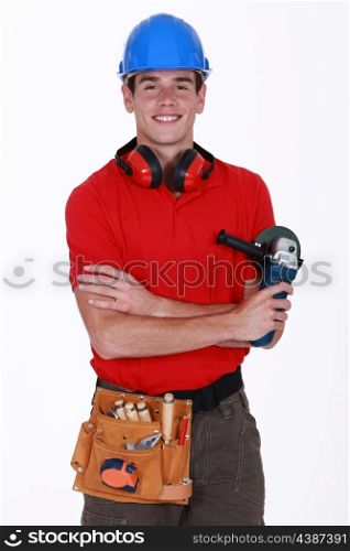 Young worker holding a sander