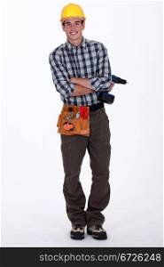 Young worker holding cordless drill