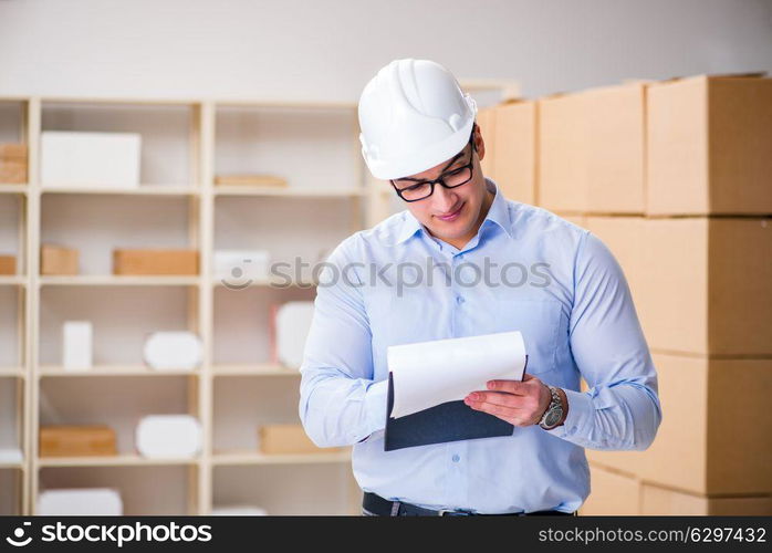 Young worker in the postal office dealing with parcels