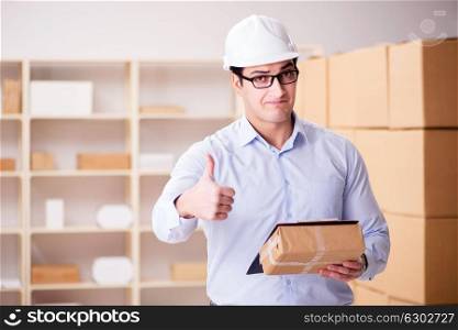 Young worker in the postal office dealing with parcels