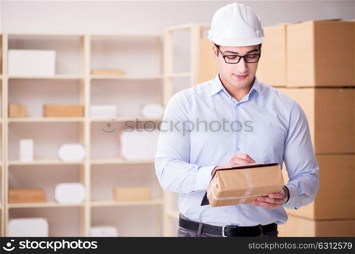 Young worker in the postal office dealing with parcels