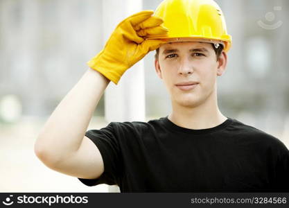 young worker on construction site, selective focus on face