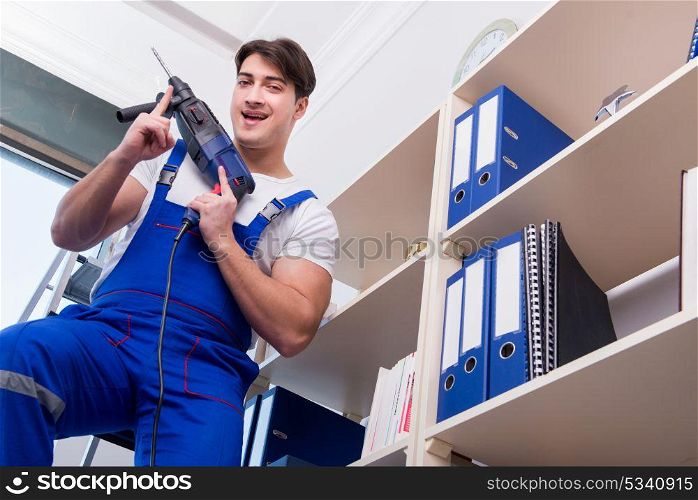 Young worker repairing shelves in office