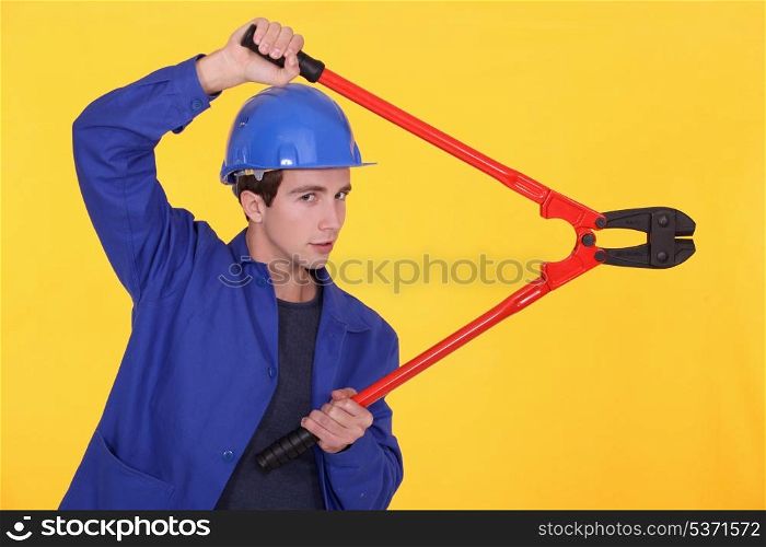 young worker using a bolt cutter