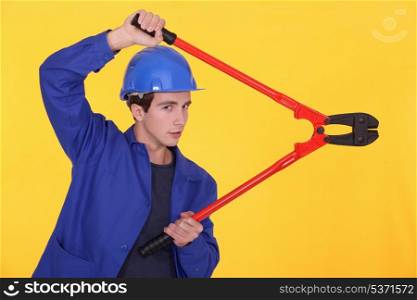 young worker using a bolt cutter