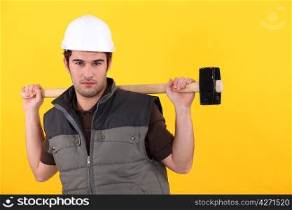 Young worker with a sledgehammer