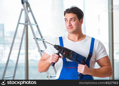 Young worker with hand drill