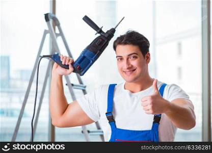 Young worker with hand drill