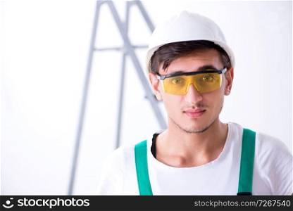 Young worker with protective equipment in safety concept 