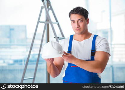 Young worker with safety helmet hardhat