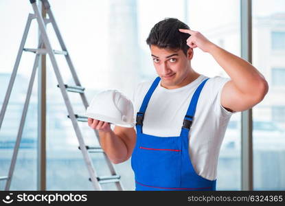 Young worker with safety helmet hardhat