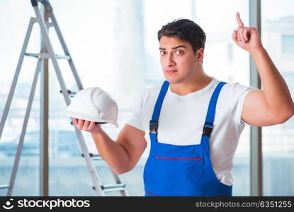 Young worker with safety helmet hardhat