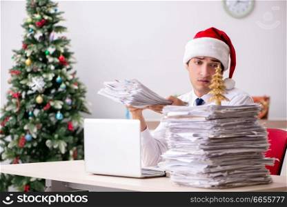 Young worker working in office on christmas shift. The young worker working in office on christmas shift