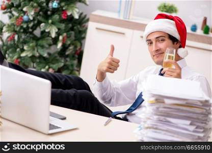 Young worker working in office on christmas shift