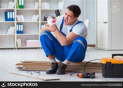 Young worker working on floor laminate tiles