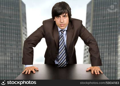 young worried business man, on a desk