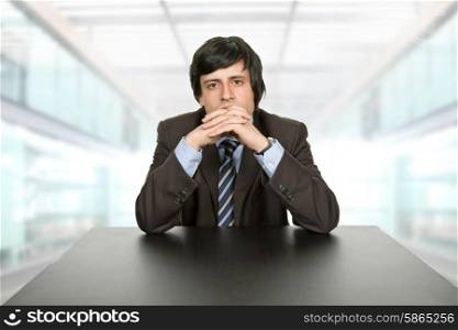 young worried businessman, on a desk, at the office