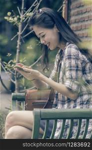 younger asian woman and smart phone in hand chat social media happiness