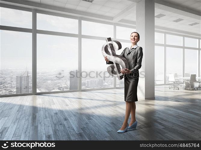 Your big interest rate . Young businesswoman holding big dollar symbol in hands