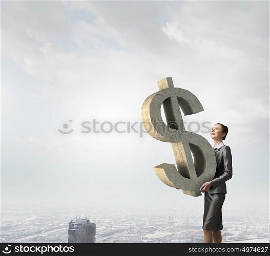 Your big interest rate. Young businesswoman holding big dollar symbol in hands