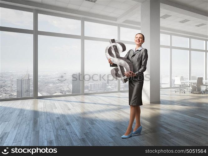 Your big interest rate . Young businesswoman holding big dollar symbol in hands