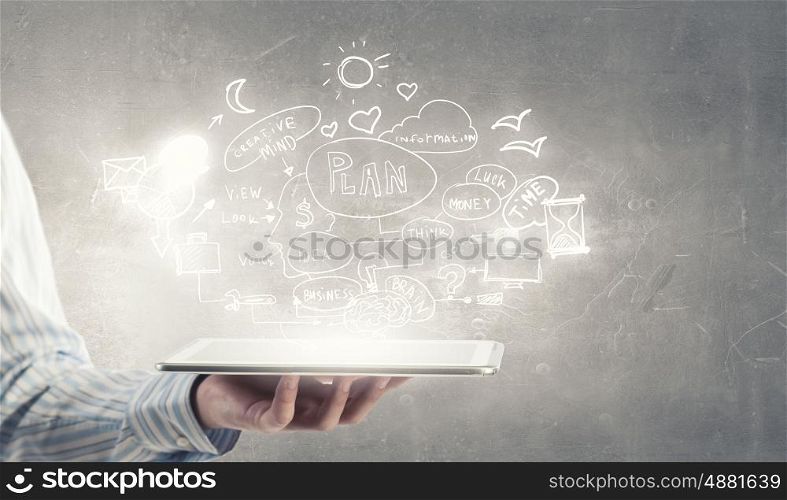 Your business organizer. Tablet pc in businessman hand and plan sketches