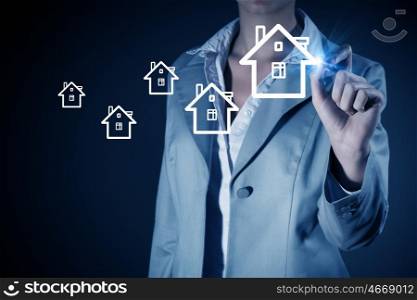 Your house. Businesswoman drawing house with pen on screen
