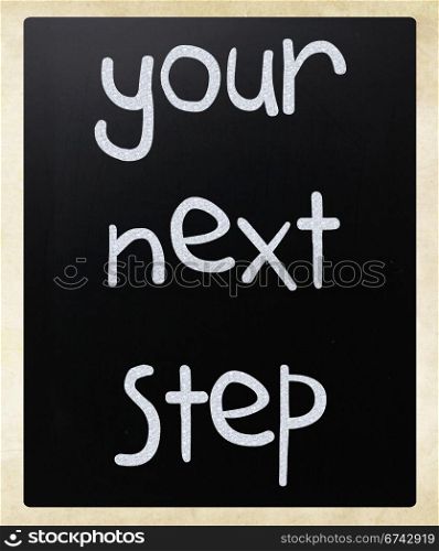 ""Your next step" handwritten with white chalk on a blackboard"