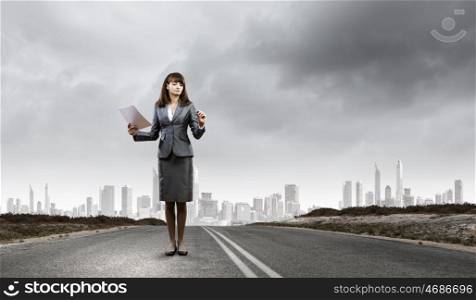 Your way of business. Businesswoman drawing business plan standing on road