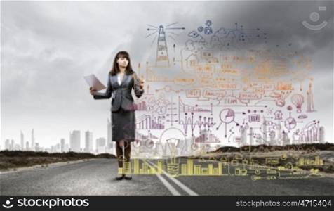 Your way of business. Businesswoman drawing business plan standing on road