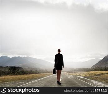 Your way to success. Businesswoman outdoor on asphalt road between two realities