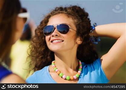 Youth and friendship. Attractive young women having fun outdoors. Summer vacation