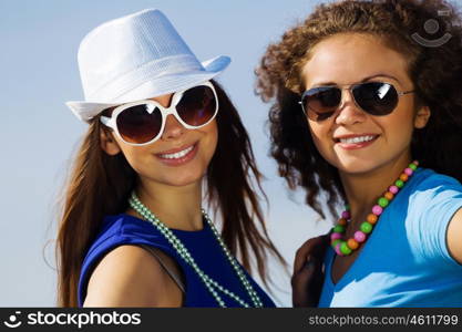 Youth and friendship. Attractive young women having fun outdoors. Summer vacation