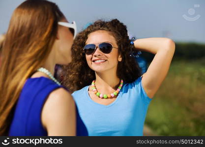 Youth and friendship. Attractive young women having fun outdoors. Summer vacation