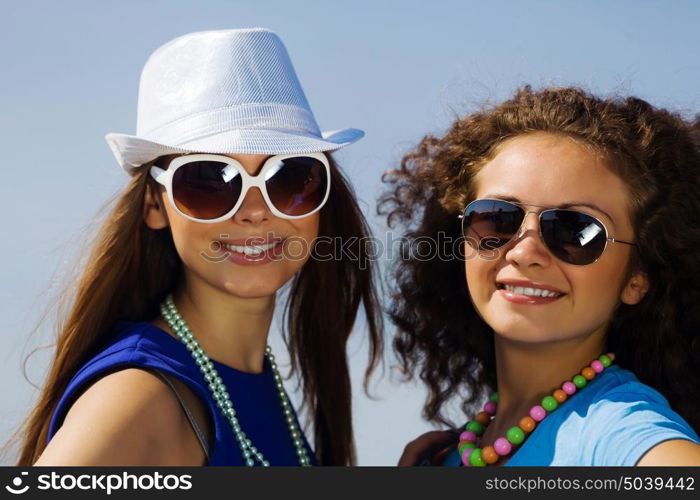 Youth and friendship. Attractive young women having fun outdoors. Summer vacation