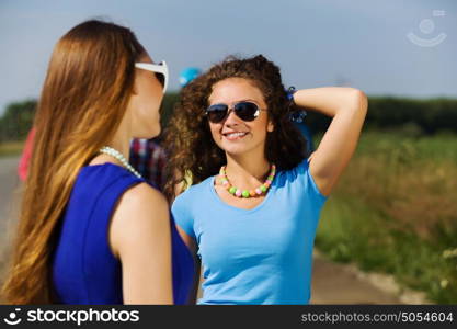 Youth and friendship. Attractive young women having fun outdoors. Summer vacation