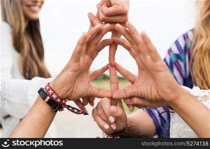 youth culture, gesture and people concept - close up of hippie friends showing peace hand sign outdoors. hands of hippie friends showing peace sign