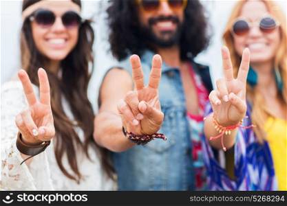 youth culture, gesture and people concept - smiling young hippie friends in sunglasses showing peace hand sign outdoors. happy young hippie friends showing peace outdoors