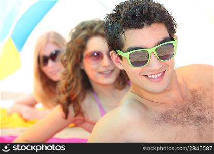 Youth on the beach wearing sunglasses