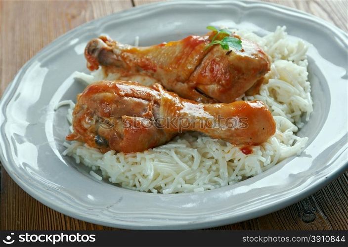 Youvetsi. Braised Chicken with pasta Tomato Based Sauce. baked Greek meat dish