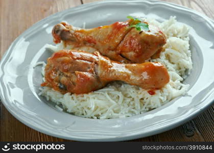 Youvetsi. Braised Chicken with pasta Tomato Based Sauce. baked Greek meat dish