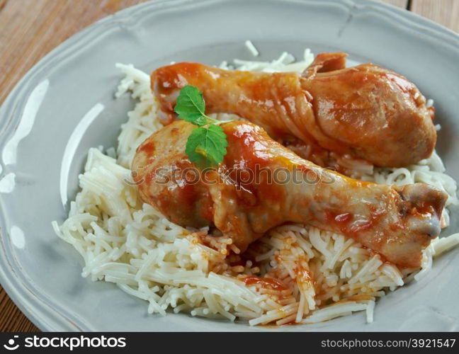 Youvetsi. Braised Chicken with pasta Tomato Based Sauce. baked Greek meat dish