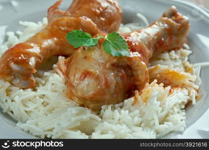 Youvetsi. Braised Chicken with pasta Tomato Based Sauce. baked Greek meat dish