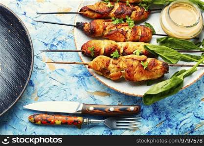 Yummy chicken meat, chicken breast barbecue on wooden skewers.. Chicken kebab skewers on a plate