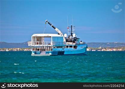 Zadar, Croatia, August 15 2019: Power Play scientific boat in Zadar channel view. Unique superyacht support vessel can ofetn be seen in Adriatic archipelago.