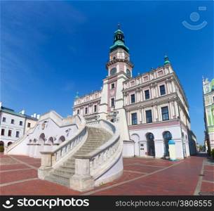 Zamosc, Poland. Historic buildings with the town hall in the Great Market. Wide angle view.