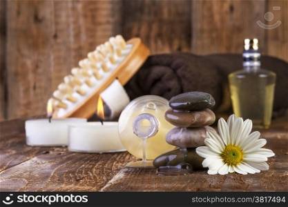 zen basalt stones and spa oil with candles on the wooden background