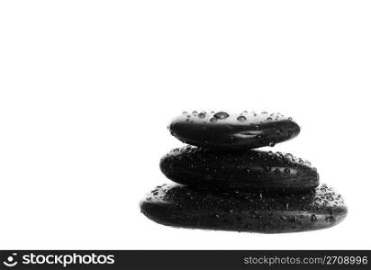 Zen massage stones with water droplets. Shot on white background.