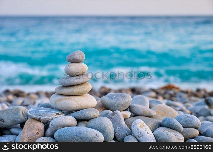 Zen meditation relaxation concept background - balanced stones stack close up on sea beach. Zen balanced stones stack on beach