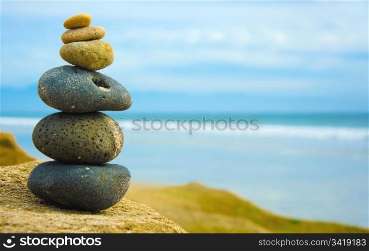 Zen Stone stacked together on blue blurred background